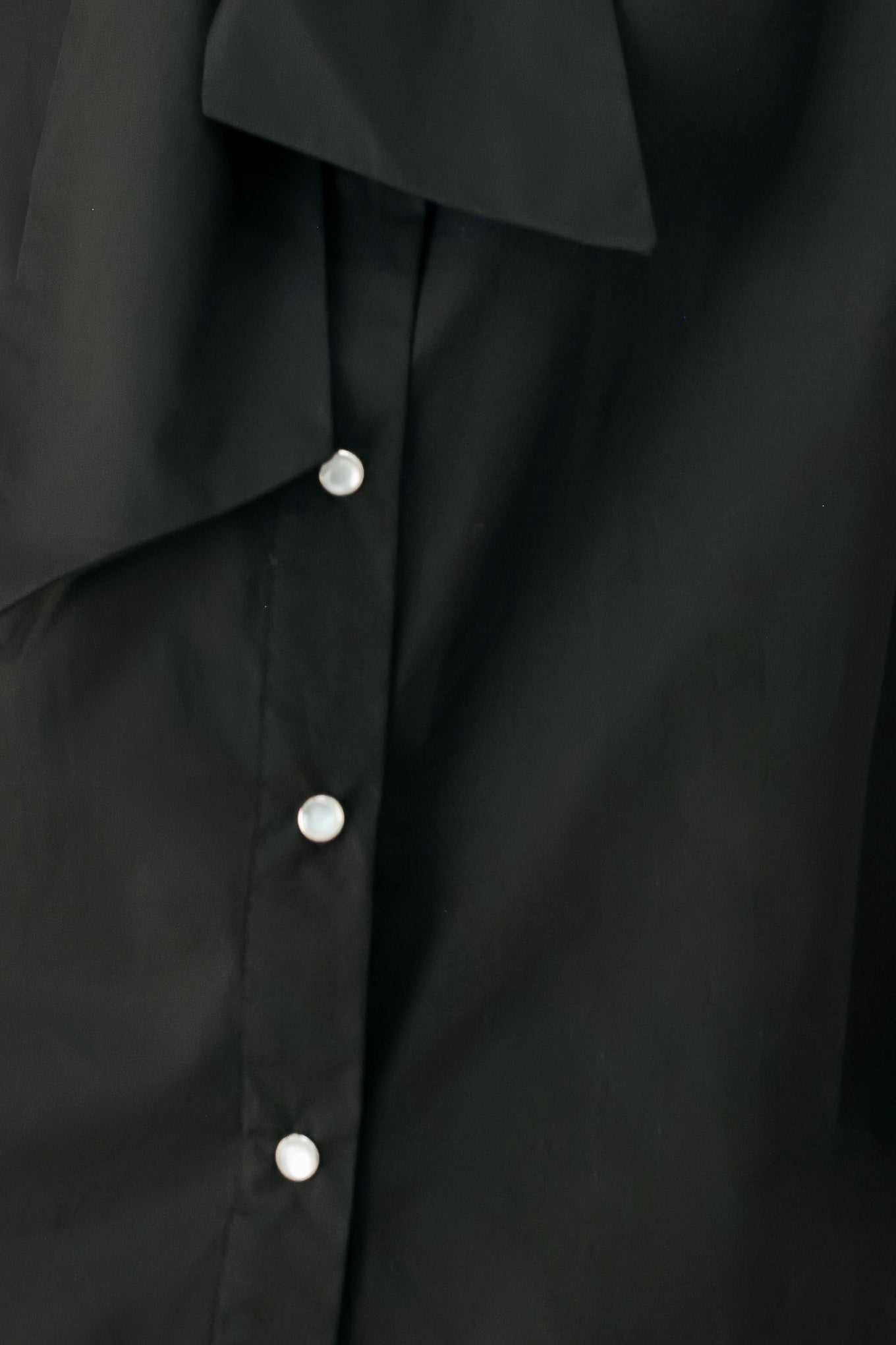 Woman wearing a black woven top with front bow tie and button down | FREEMARKET
