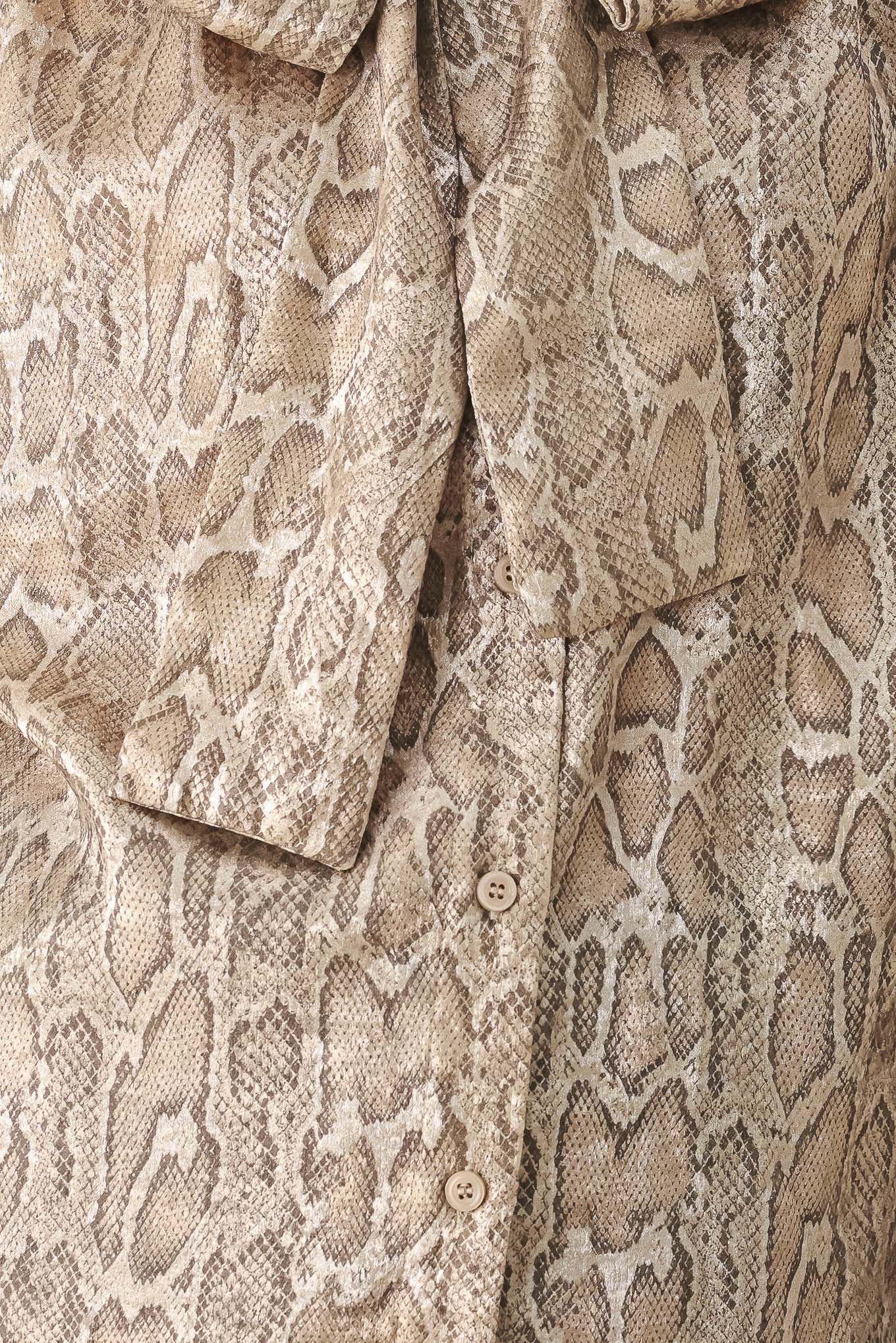 A woman modeling a long-sleeve brown and gold snake-patterned blouse with a tie-neck detail | FREEMARKET