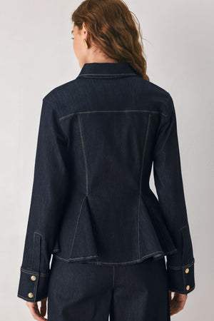 Woman wearing a navy blue denim long sleep button up top with a peplum waist, a collar and chain connected to the corners of the collar | FREEMARKET