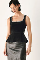 A woman modeling a black velvet sleeveless top with a pearl-trimmed square neckline and a peplum waist | FREEMARKET