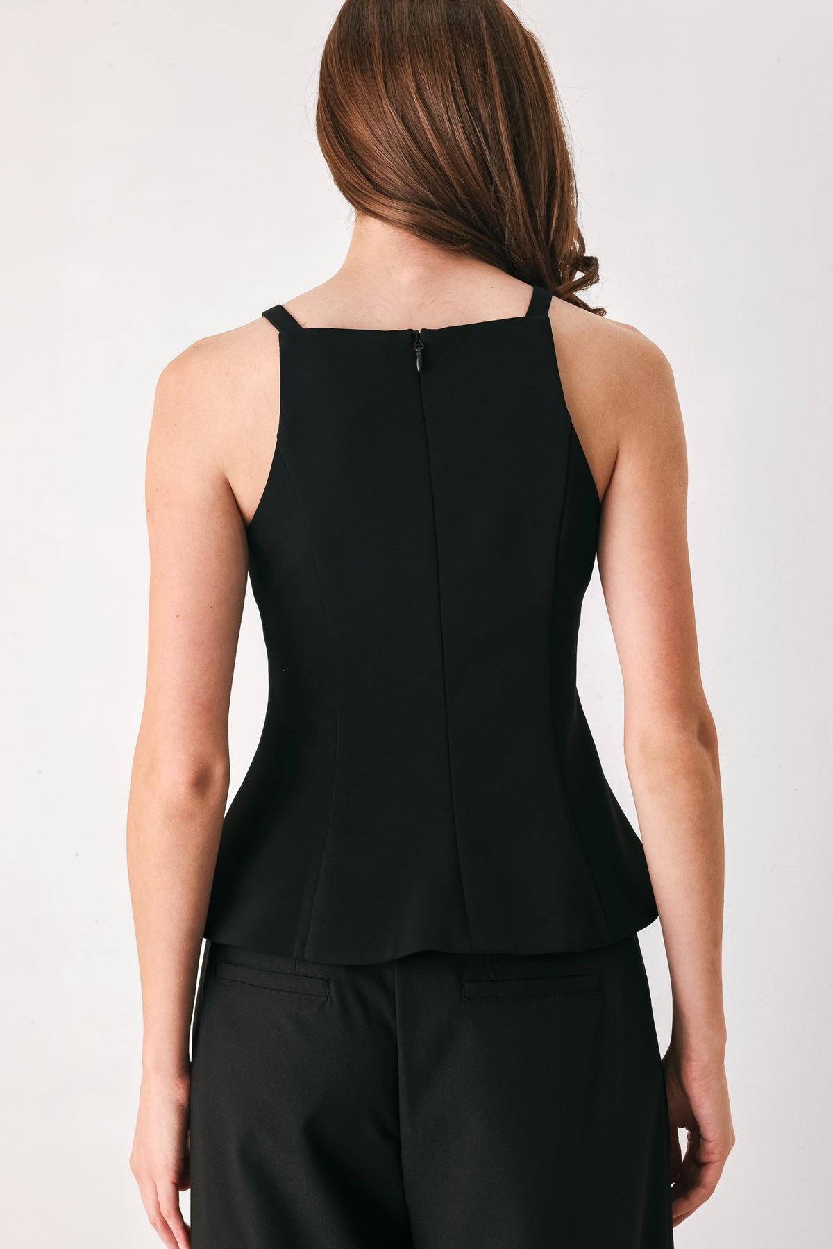 A woman wearing a black sleeveless top with bow details | FREEMARKET