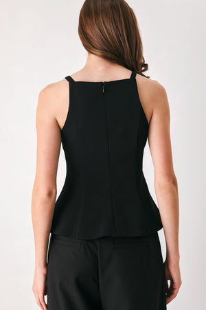 A woman wearing a black sleeveless top with bow details | FREEMARKET