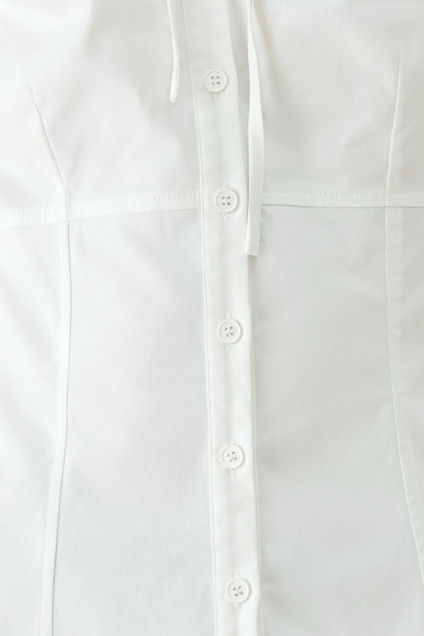A woman wearing a white short-sleeve blouse with puff sleeves, a ruffled collar, and a keyhole cutout at the neckline | FREEMARKET