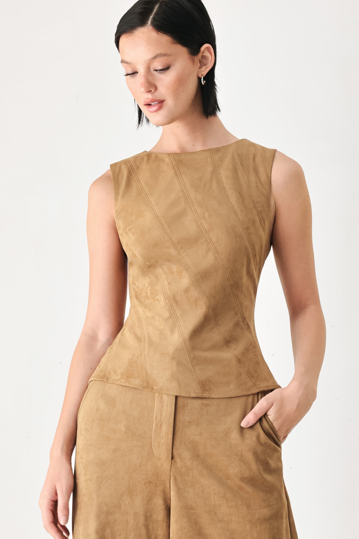 A woman wearing a faux suede camel  top width diagonal stitches and back zipper | FREEMARKET