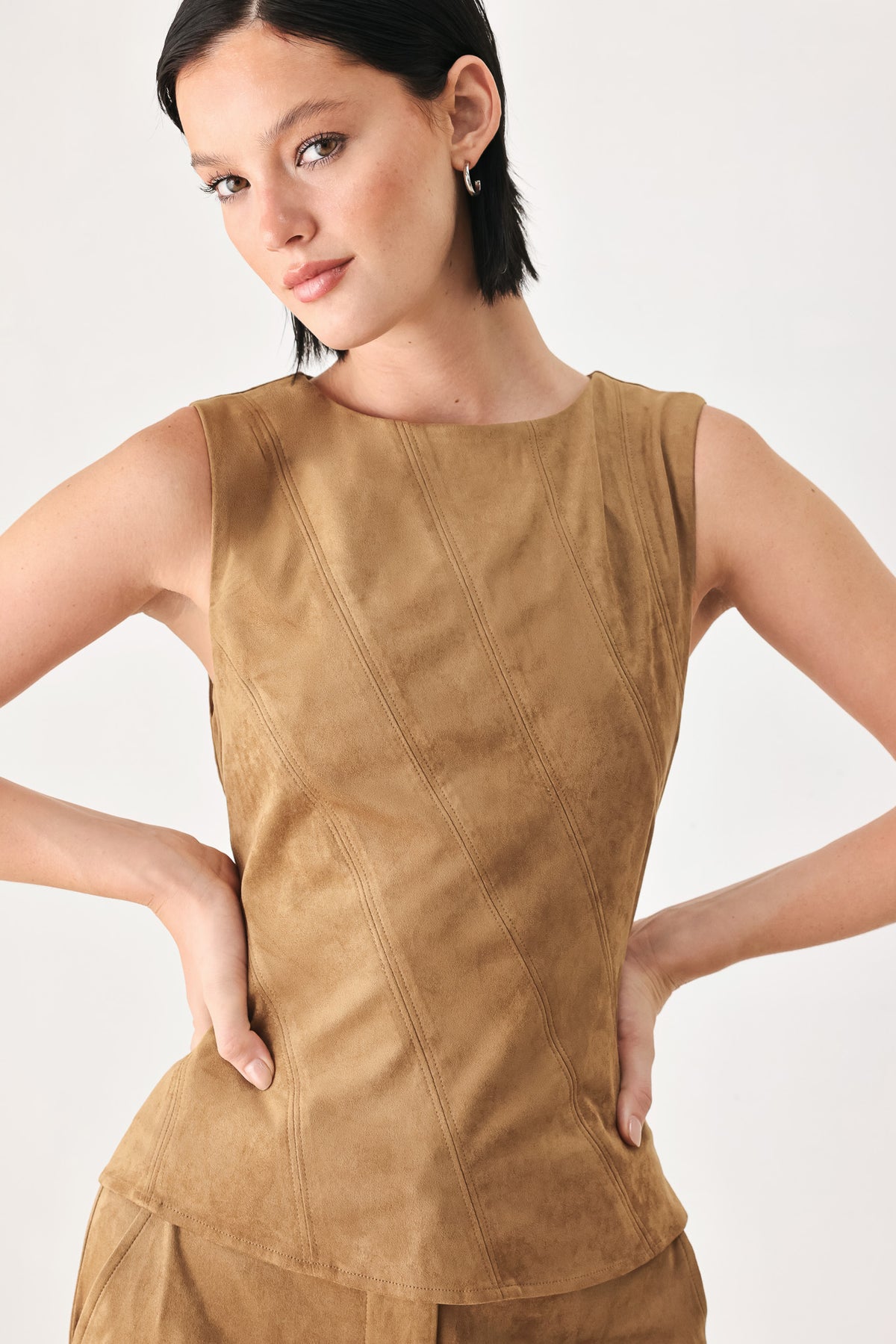 A woman wearing a faux suede camel  top width diagonal stitches and back zipper | FREEMARKET