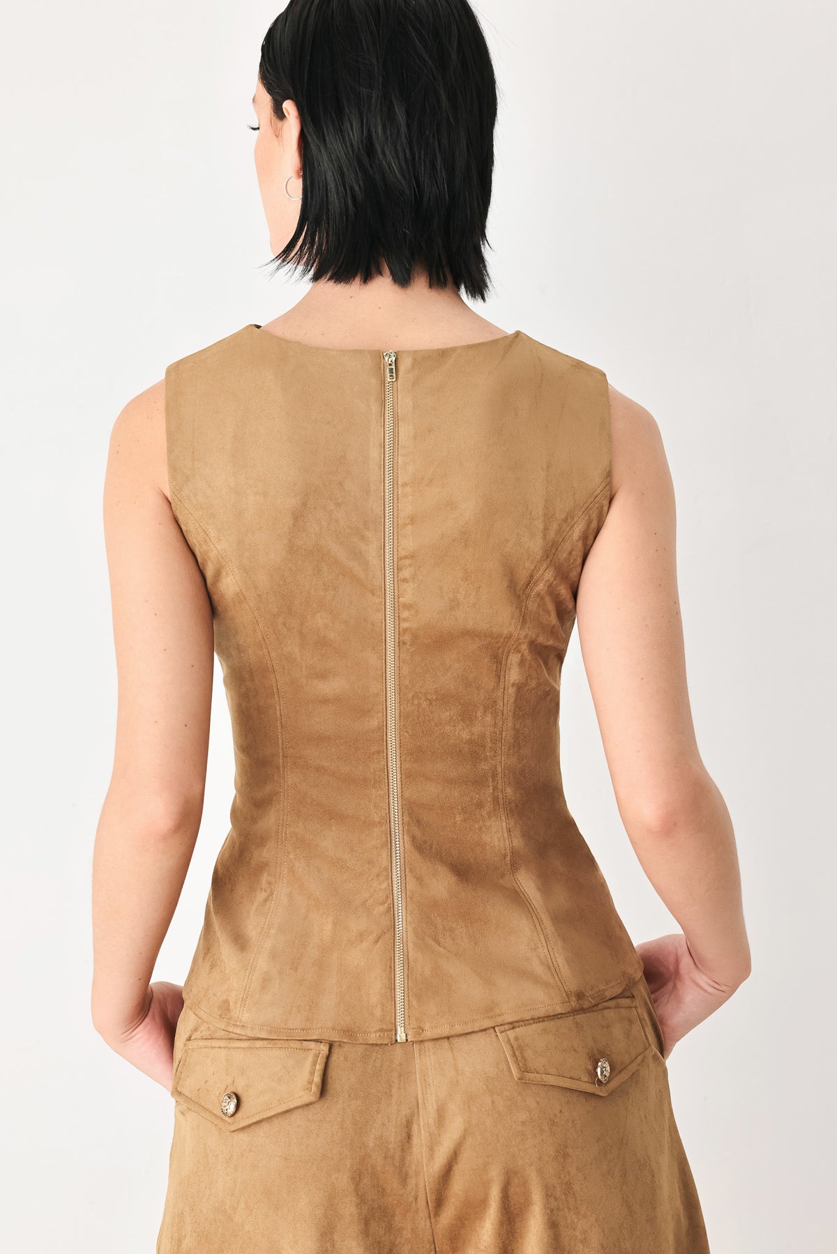 A woman wearing a faux suede camel  top width diagonal stitches and back zipper | FREEMARKET