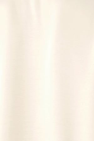 A woman wearing a cream-colored long-sleeve blouse with a tie-neck detail | FREEMARKET