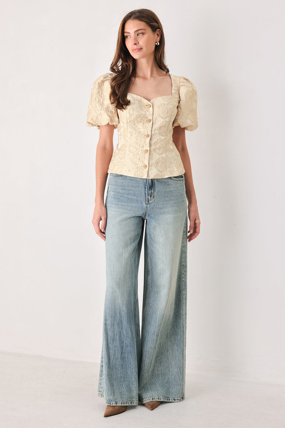 A woman wearing a beige gold jacquard corset-style blouse with puff sleeves and a sweetheart neckline | FREEMARKET