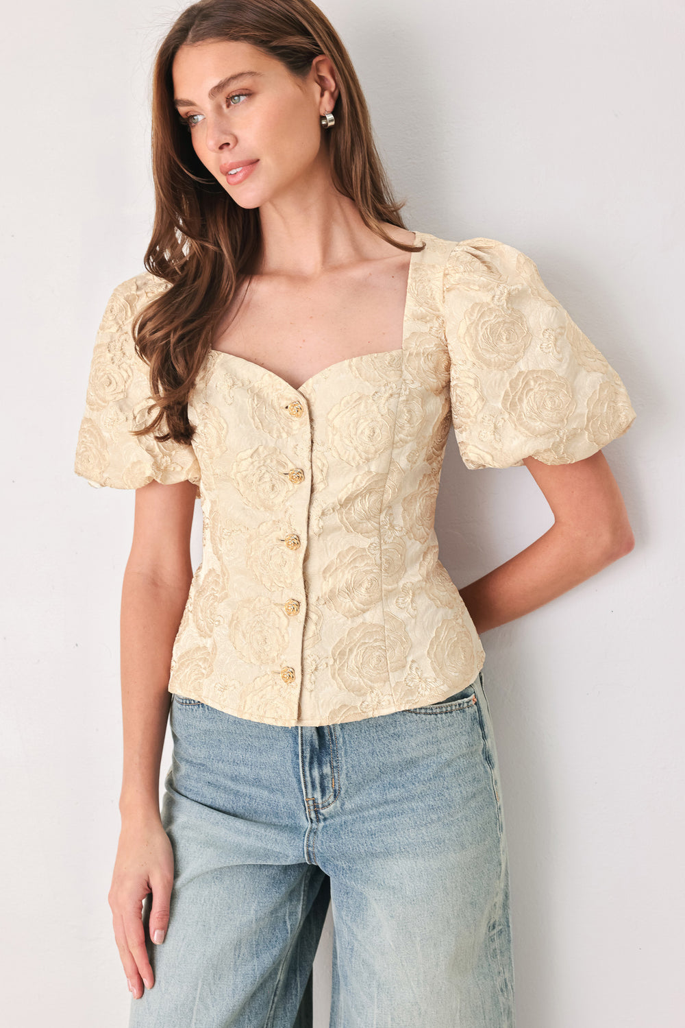 A woman wearing a beige gold jacquard corset-style blouse with puff sleeves and a sweetheart neckline | FREEMARKET