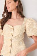 A woman wearing a beige gold jacquard corset-style blouse with puff sleeves and a sweetheart neckline | FREEMARKET