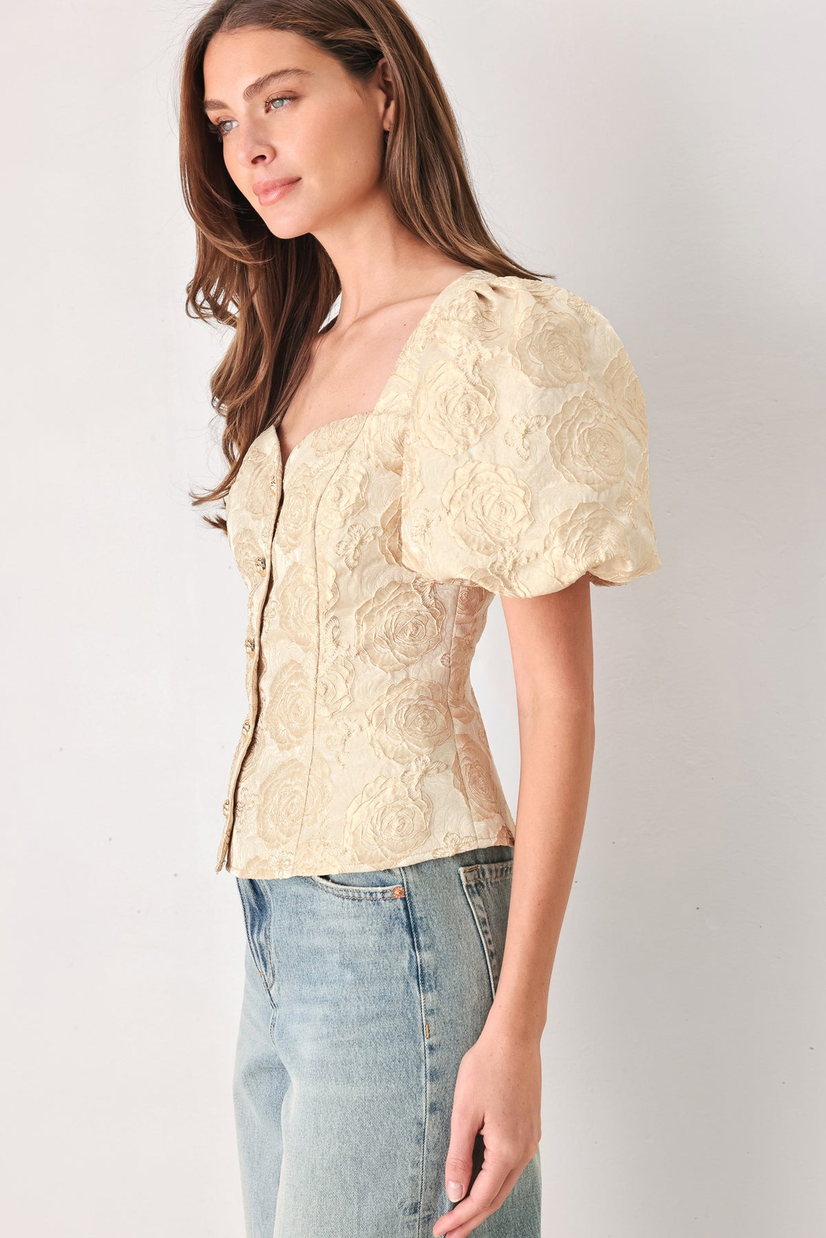 A woman wearing a beige gold jacquard corset-style blouse with puff sleeves and a sweetheart neckline | FREEMARKET