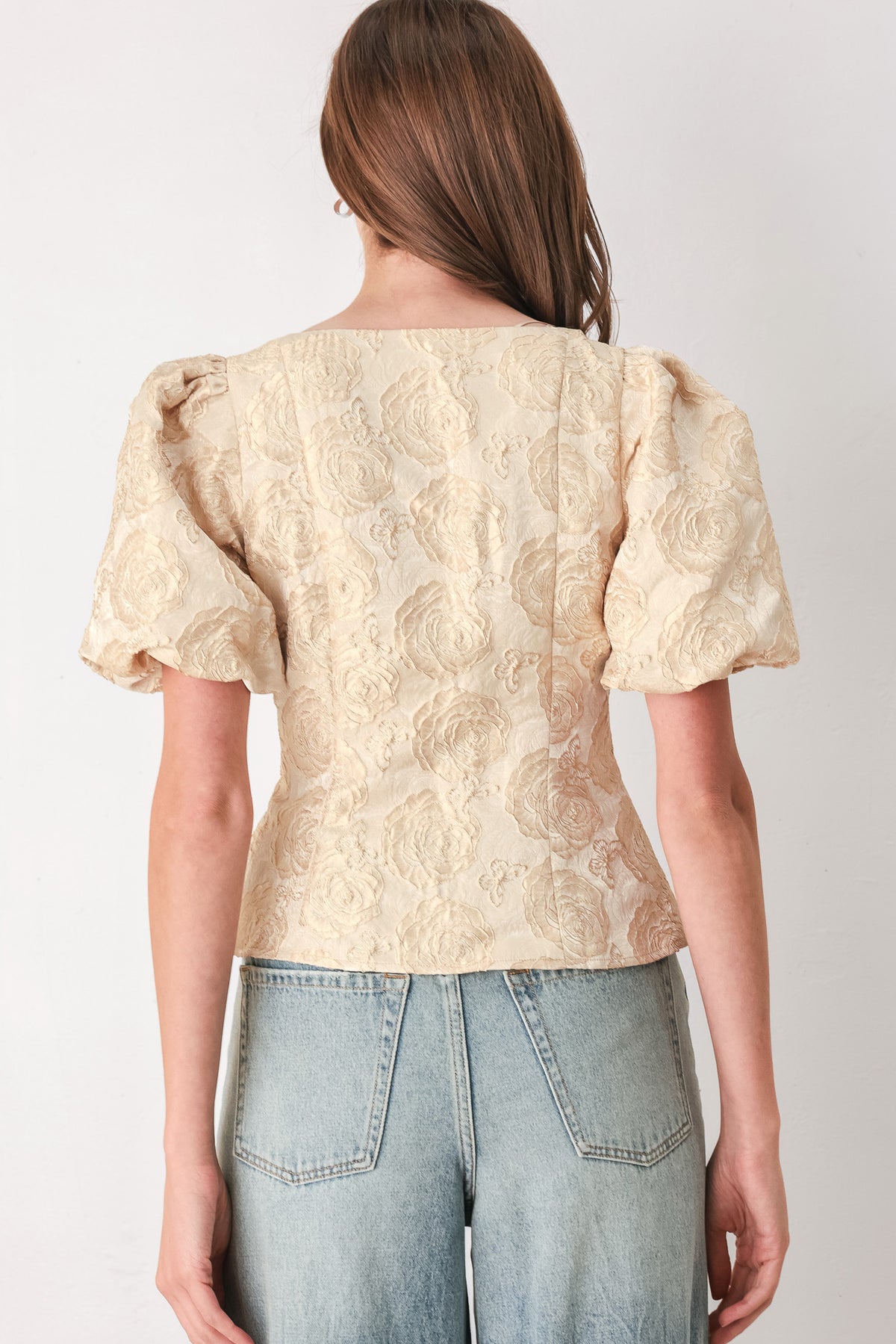 A woman wearing a beige gold jacquard corset-style blouse with puff sleeves and a sweetheart neckline | FREEMARKET