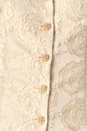 A woman wearing a beige gold jacquard corset-style blouse with puff sleeves and a sweetheart neckline | FREEMARKET