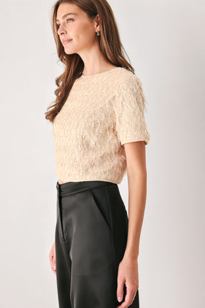 Woman wearing a champagne short sleeve crop top with sequin and faux feather/fur | FREEMARKET