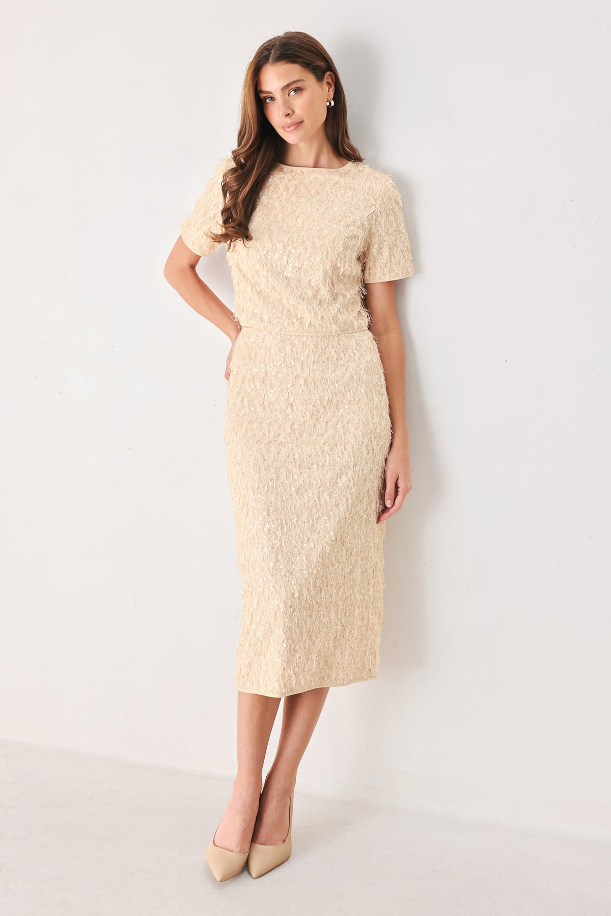 Woman wearing a champagne short sleeve crop top with sequin and faux feather/fur | FREEMARKET