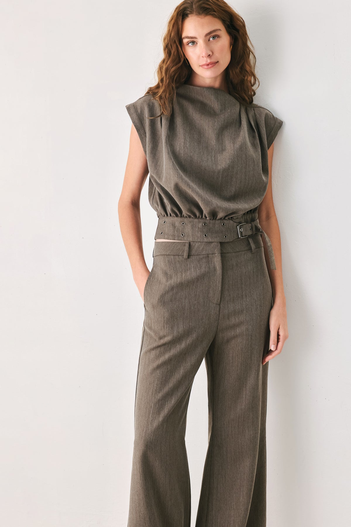 Woman wearing a brown cap sleeve top with waist belt detail | FREEMARKET