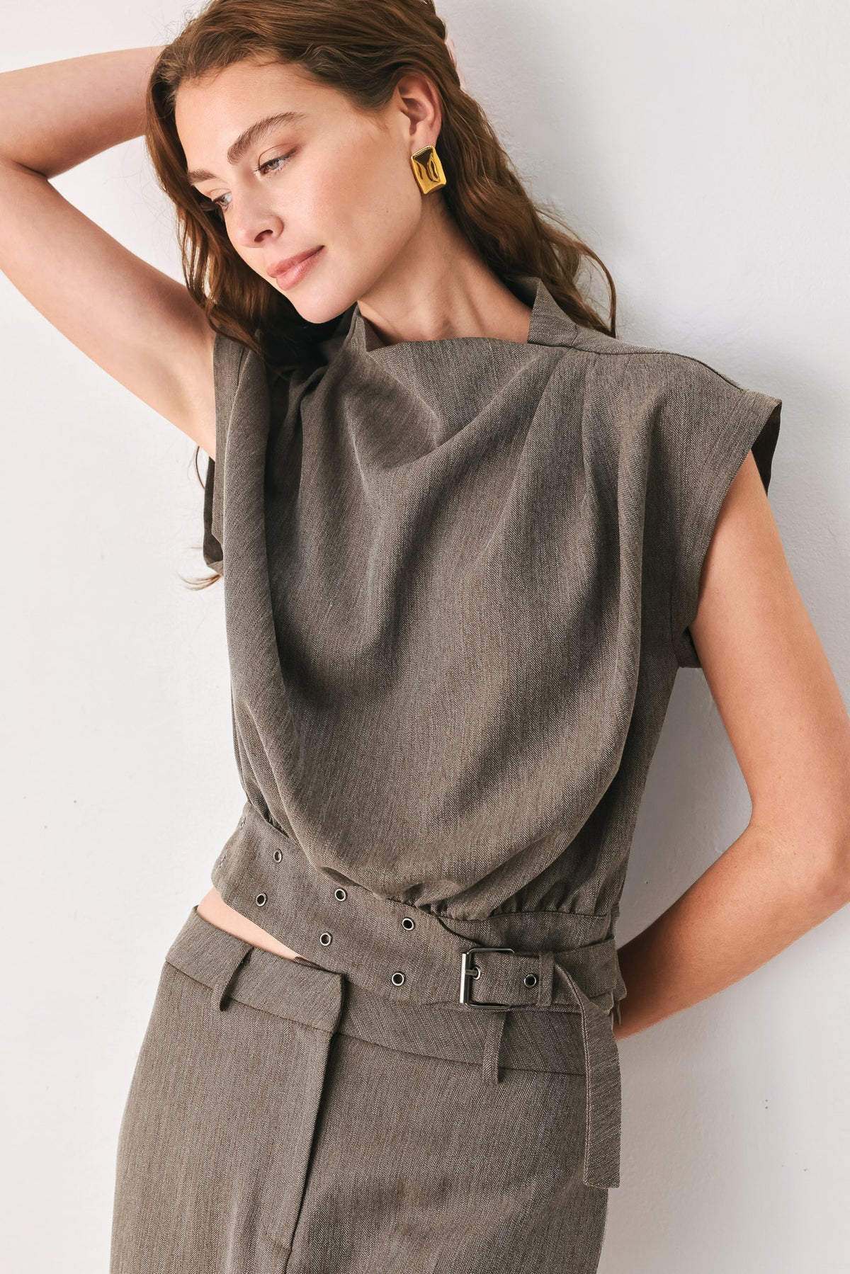 Woman wearing a brown cap sleeve top with waist belt detail | FREEMARKET