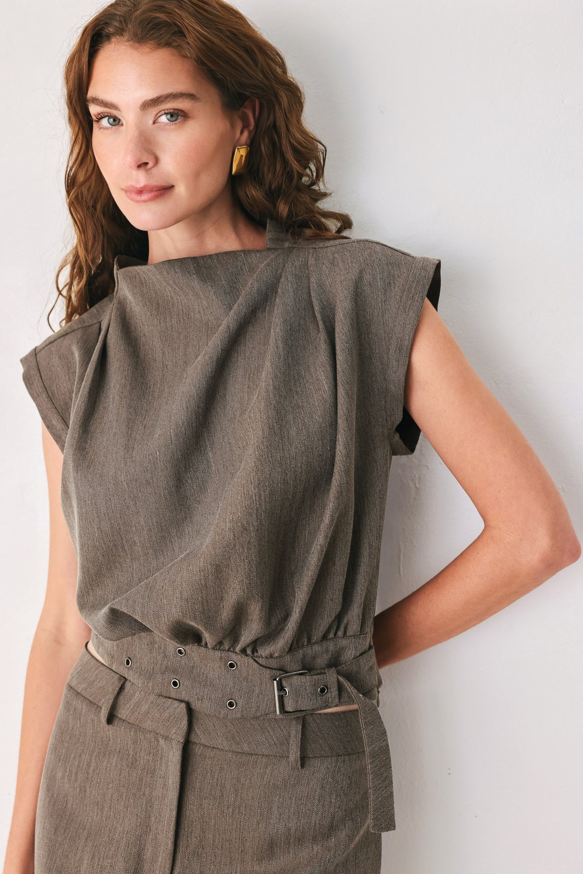 Woman wearing a brown cap sleeve top with waist belt detail | FREEMARKET