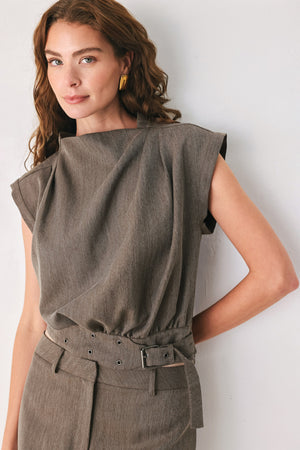 Woman wearing a brown cap sleeve top with waist belt detail | FREEMARKET