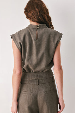 Woman wearing a brown cap sleeve top with waist belt detail | FREEMARKET