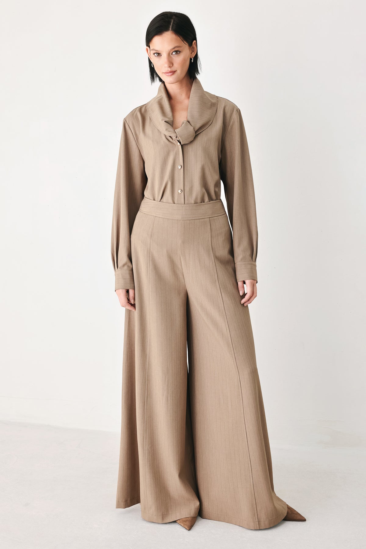 A woman wearing a taupe-beige long-sleeve button-front blouse with a large draped collar | FREEMARKET