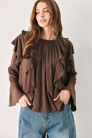 Woman wearing a long sleeve brown top with ruffles | FREEMARKET