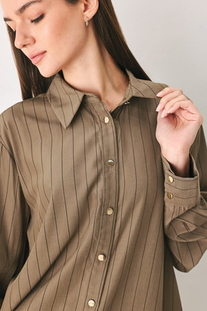 Woman wearing a brown button up long sleeve top with thin vertical black lines | FREEMARKET