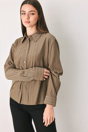 Woman wearing a brown button up long sleeve top with thin vertical black lines | FREEMARKET