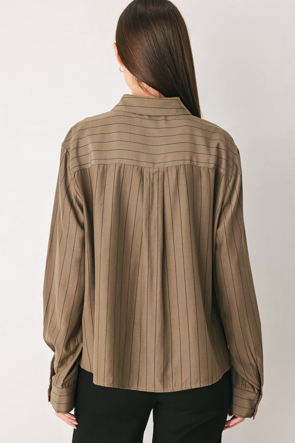 Woman wearing a brown button up long sleeve top with thin vertical black lines | FREEMARKET