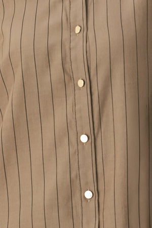 Woman wearing a brown button up long sleeve top with thin vertical black lines | FREEMARKET