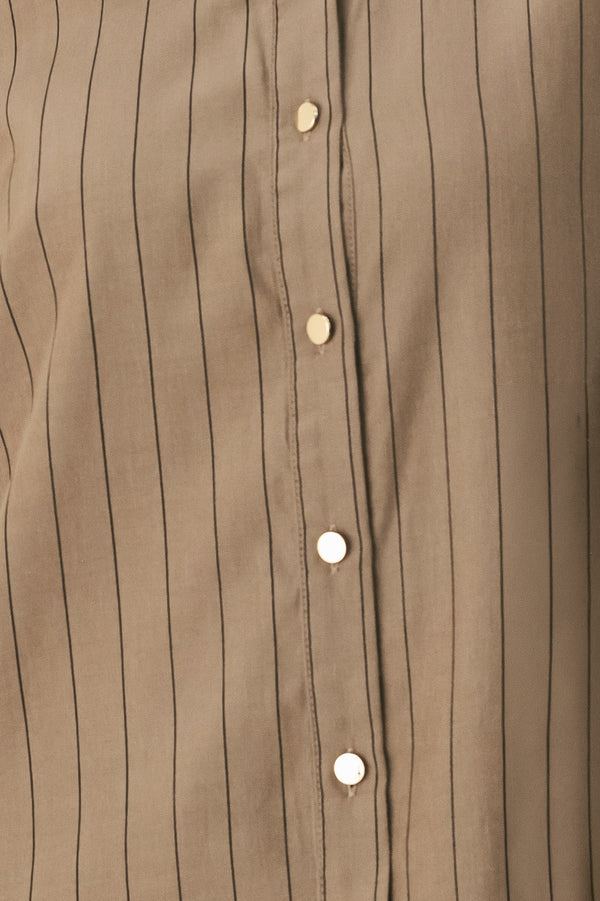 Woman wearing a brown button up long sleeve top with thin vertical black lines | FREEMARKET