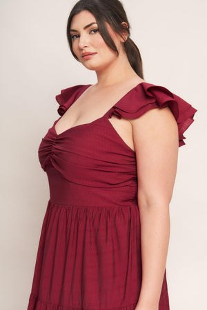 A solid woven maxi dress featuring cami top with layered sleeve, cinched front bodice, tiered skirt and smocked back bodice. FLYING TOMATO