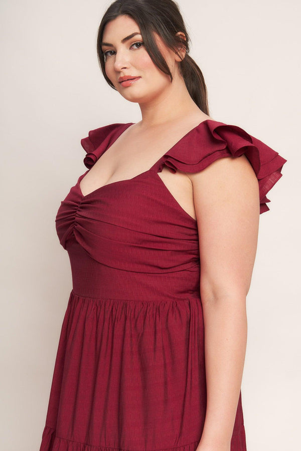 A solid woven maxi dress featuring cami top with layered sleeve, cinched front bodice, tiered skirt and smocked back bodice. FLYING TOMATO