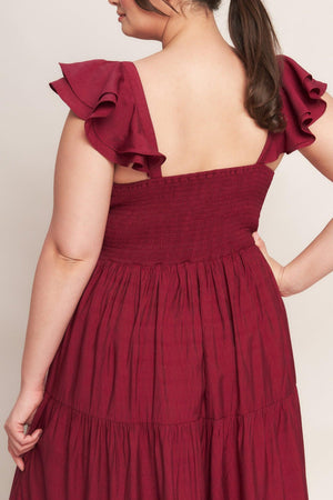 A solid woven maxi dress featuring cami top with layered sleeve, cinched front bodice, tiered skirt and smocked back bodice. FLYING TOMATO