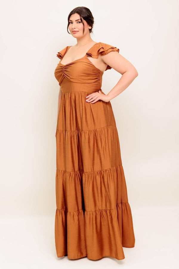 A solid woven maxi dress featuring cami top with layered sleeve, cinched front bodice, tiered skirt and smocked back bodice.
