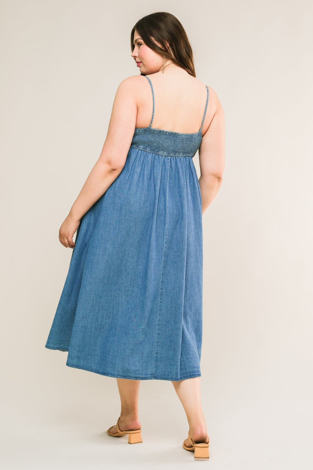 
An artfully washed midi dress in soft denim, boasting a sleek straight neckline and delicate shoulder straps finished with inverted pleats. The exquisite back tie closure adds a touch of elegance to this effortlessly chic piece.
Details:

Self : 90% Cotton 10% Polyester

Size &amp; Fit

- Model is 5`7" And Wearing Size Small
- Measurements Taken From Size Small
- Approx. Length: 51"