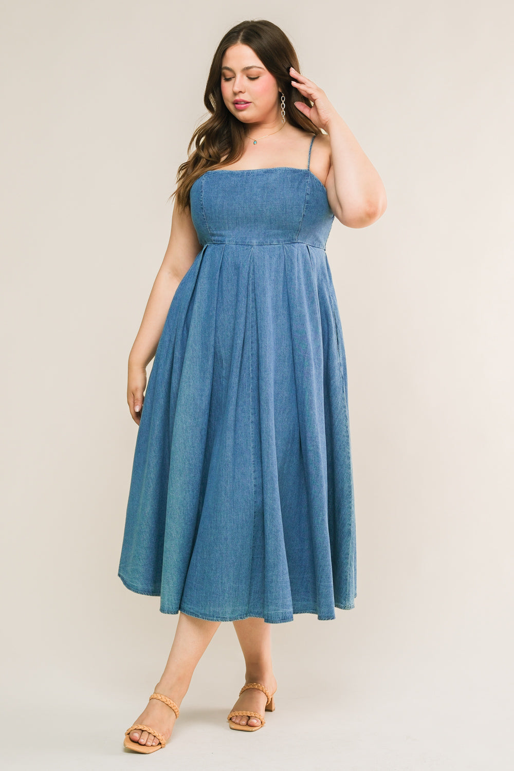 
An artfully washed midi dress in soft denim, boasting a sleek straight neckline and delicate shoulder straps finished with inverted pleats. The exquisite back tie closure adds a touch of elegance to this effortlessly chic piece.
Details:

Self : 90% Cotton 10% Polyester

Size &amp; Fit

- Model is 5`7" And Wearing Size Small
- Measurements Taken From Size Small
- Approx. Length: 51"