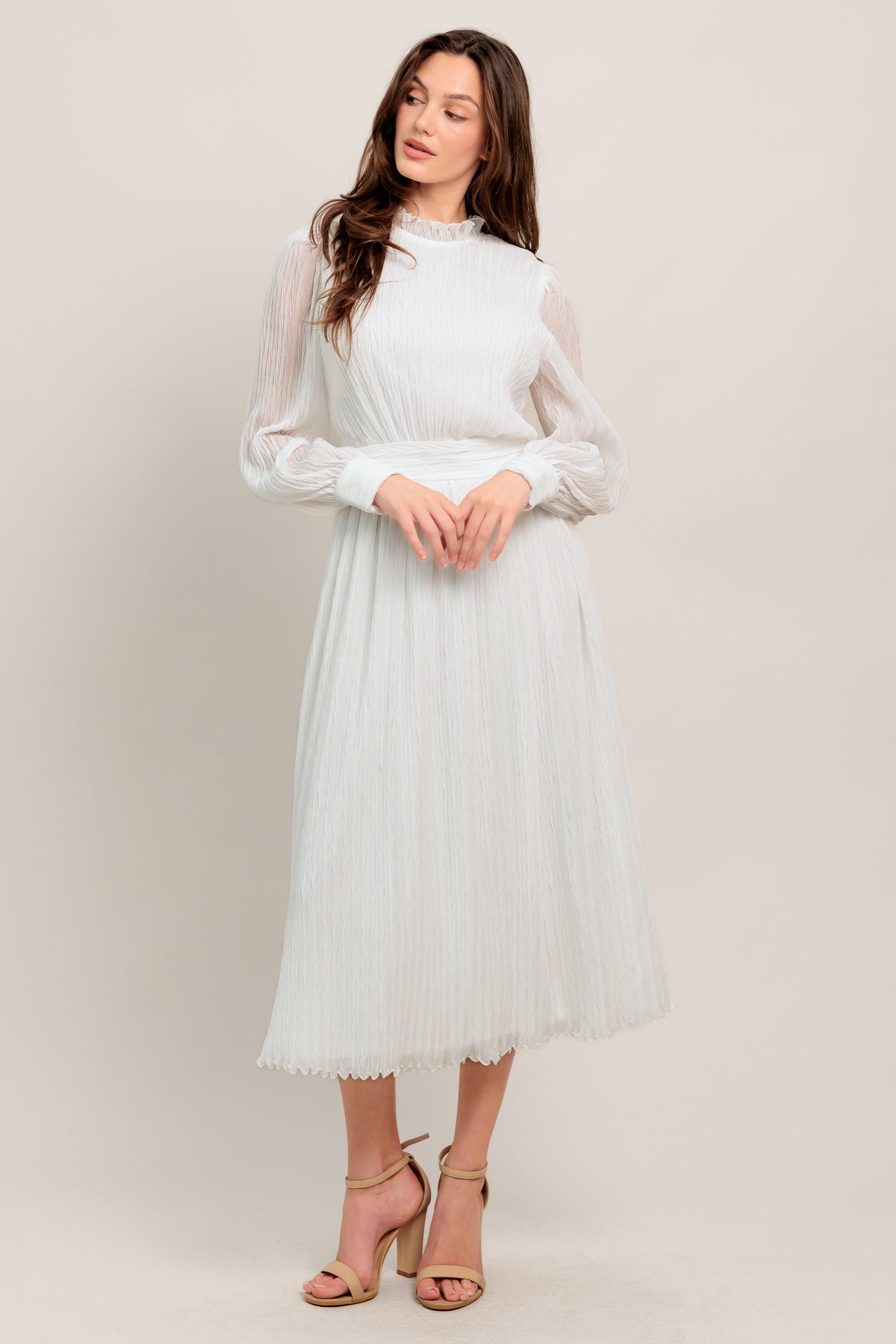 
A textured woven midi dress featuring high neckline with ruffled edge, long sleeve with cuff, full skirt and back zipper closure

Details:

Self : 100% Polyester
Lining: 100% Polyester

Size &amp; Fit

- Model is 5`7" And Wearing Size Small
- Measurements Taken From Size Small
- Approx. Length: 48"