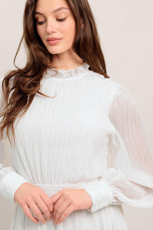 
A textured woven midi dress featuring high neckline with ruffled edge, long sleeve with cuff, full skirt and back zipper closure

Details:

Self : 100% Polyester
Lining: 100% Polyester

Size &amp; Fit

- Model is 5`7" And Wearing Size Small
- Measurements Taken From Size Small
- Approx. Length: 48"