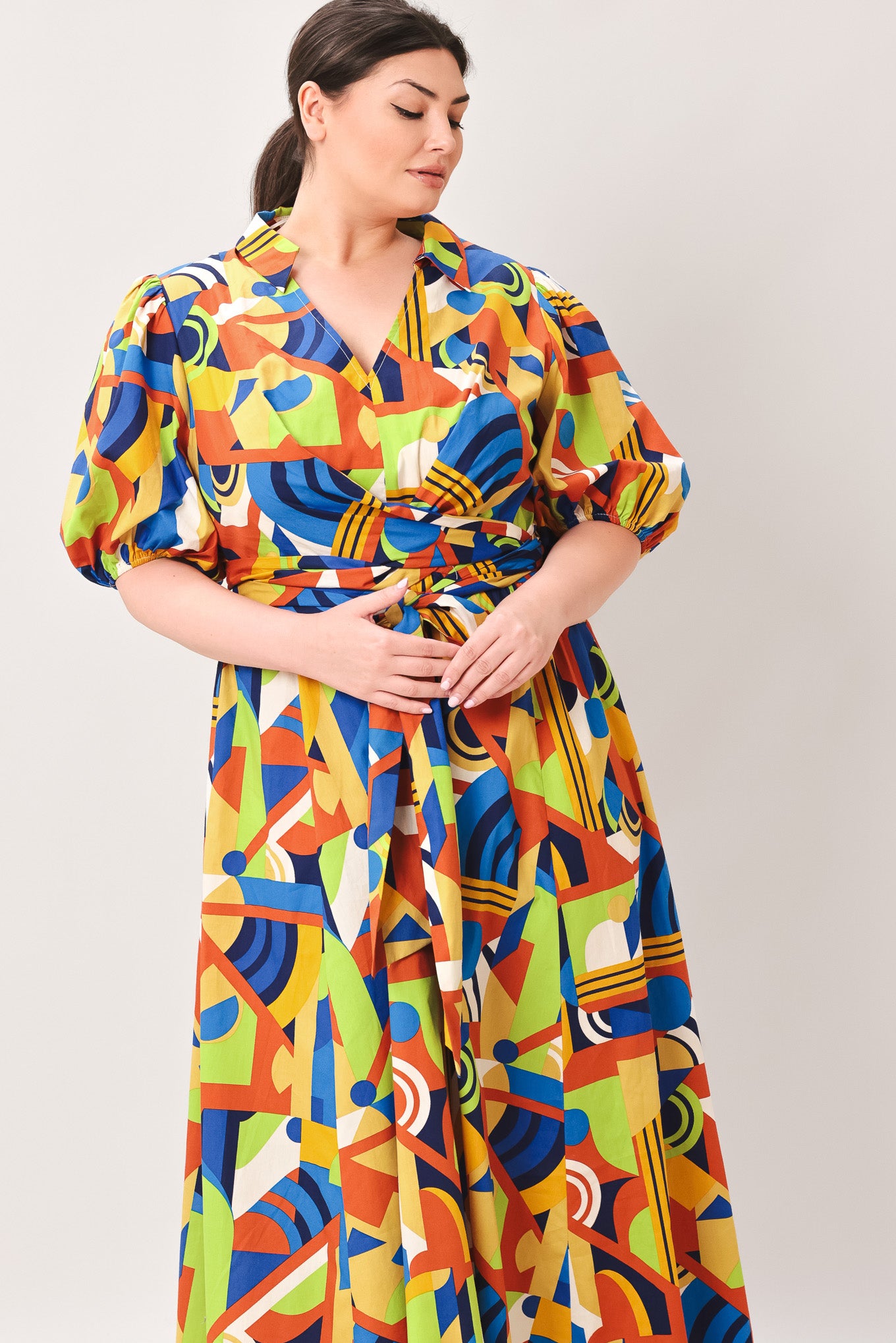 Woman wearing a colorful patterned dress on a white background | Curve | Flying Tomato