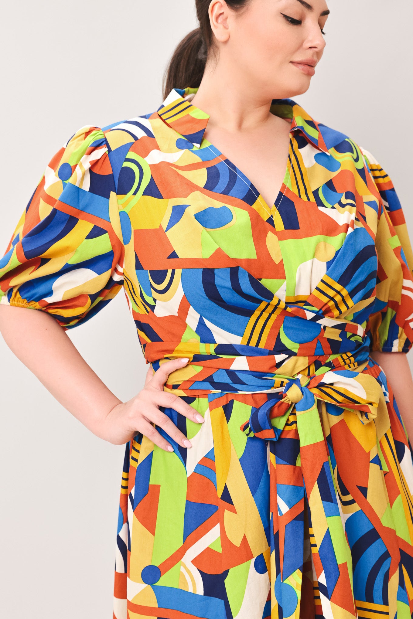 Woman wearing a colorful patterned dress on a white background | Curve | Flying Tomato