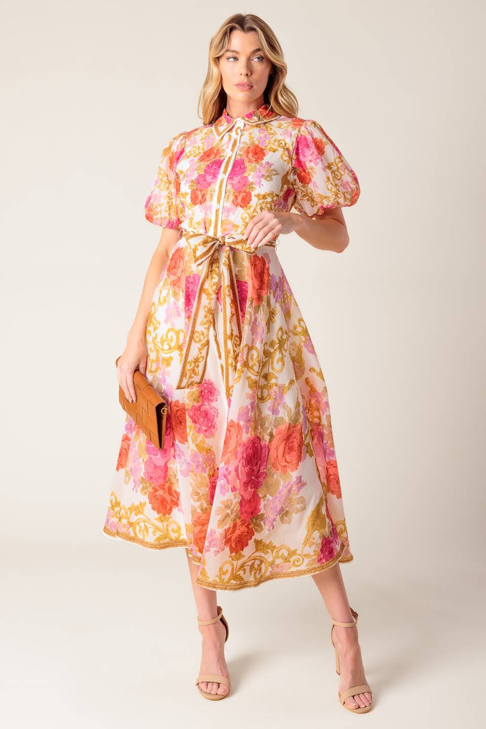 A printed woven midi dress featuring shirt collar, short puff sleeve, button down, self sash belt and full skirt.