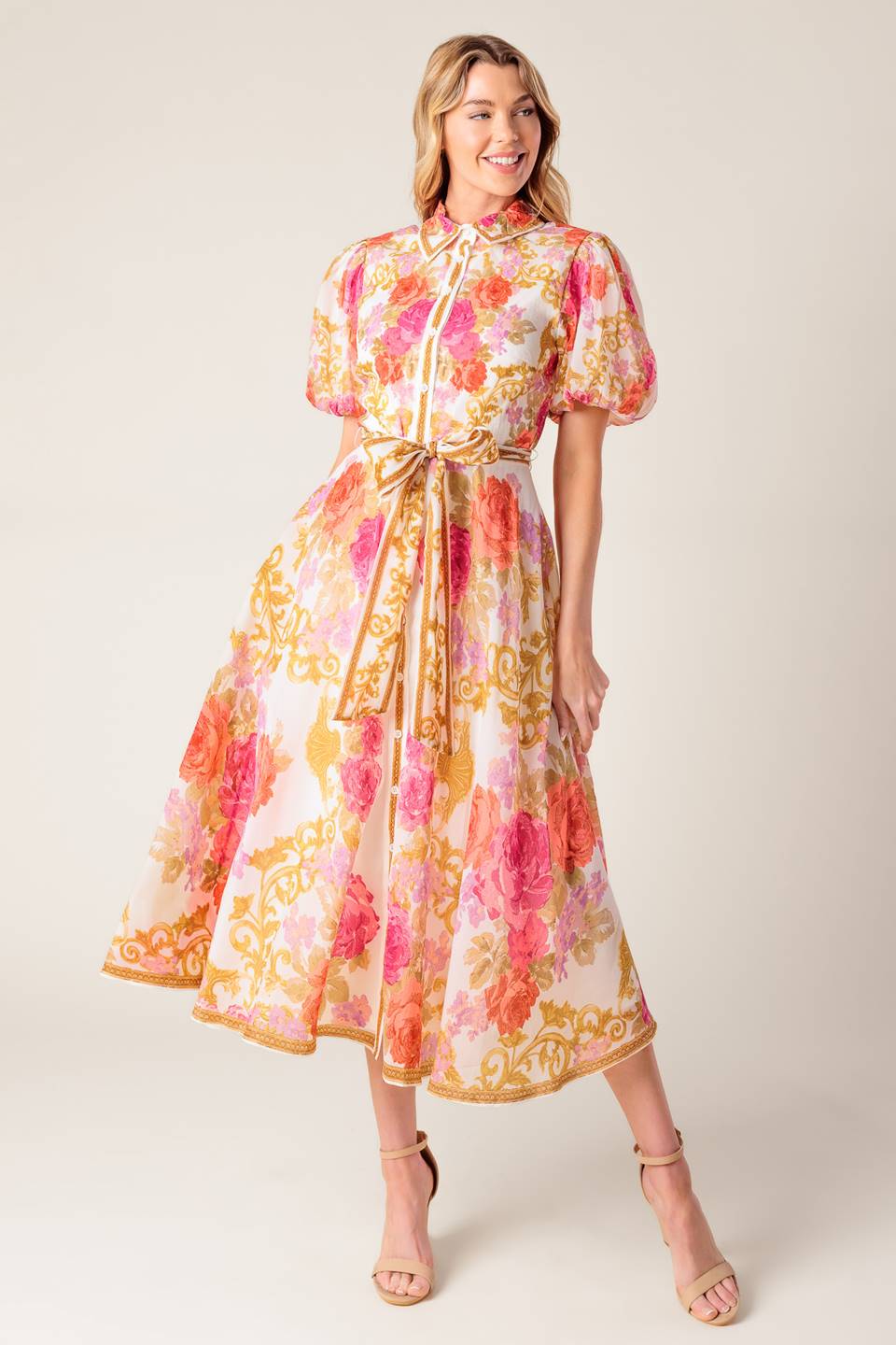 A printed woven midi dress featuring shirt collar, short puff sleeve, button down, self sash belt and full skirt.