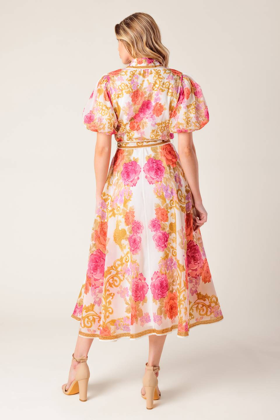 A printed woven midi dress featuring shirt collar, short puff sleeve, button down, self sash belt and full skirt.