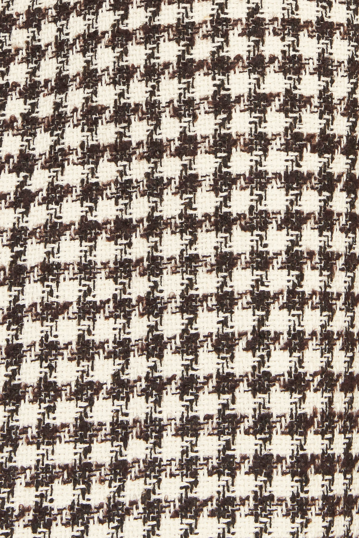 A tweed mini dress featuring round neckline, short sleeve, front button detail, A line skirt and back zipper closure