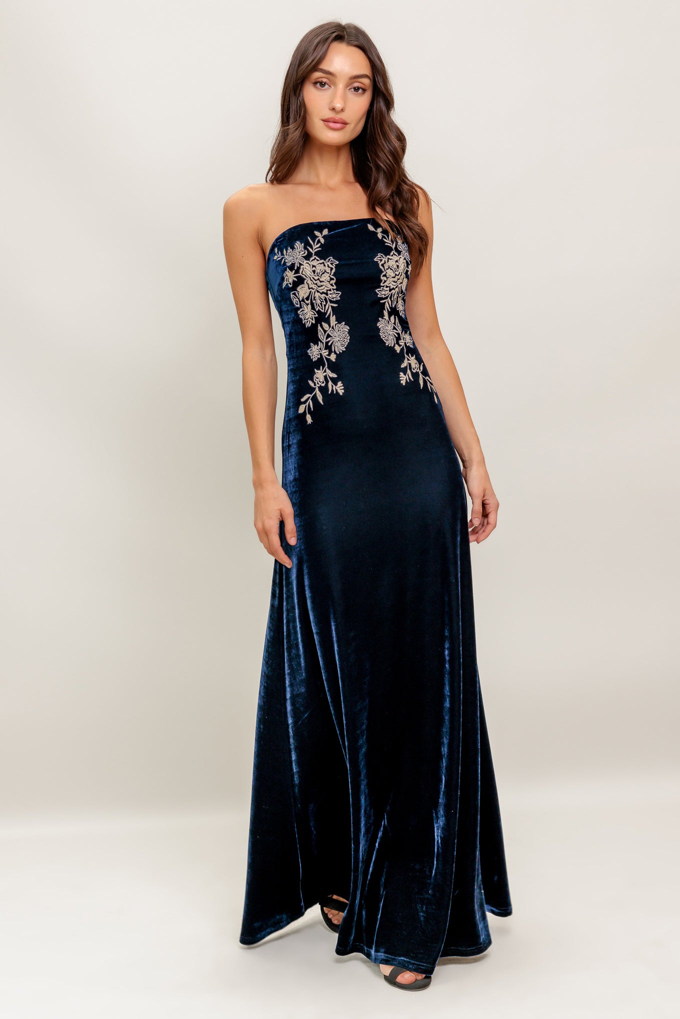 A velvet maxi dress featuring strapless, embroidered bodice and back zipper closure