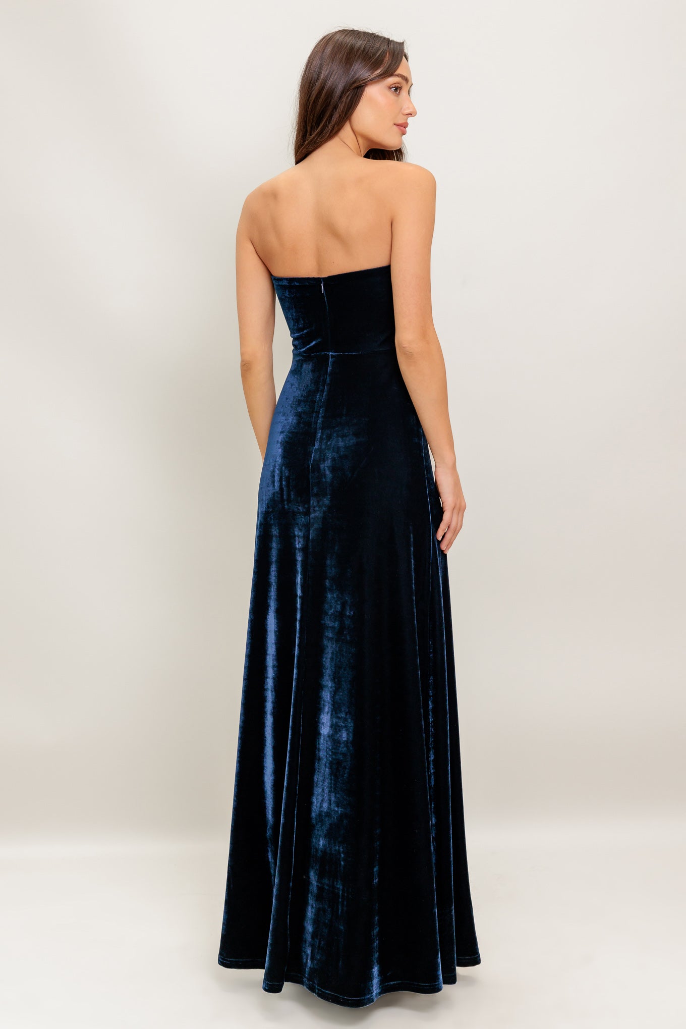 A velvet maxi dress featuring strapless, embroidered bodice and back zipper closure
