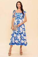 A printed woven midi dress featuring straight neckline, shoulder strap, circle skirt and back zipper closure