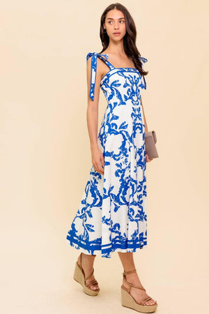 A printed woven midi dress featuring straight neckline, shoulder strap, circle skirt and back zipper closure