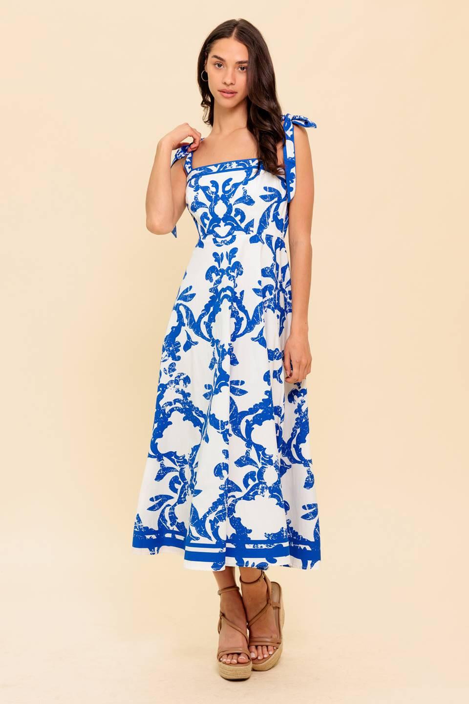 A printed woven midi dress featuring straight neckline, shoulder strap, circle skirt and back zipper closure